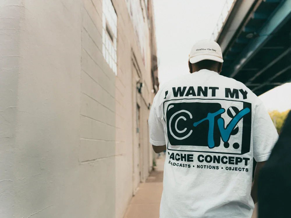 I Want My CCTV Cache Concept T-shirt photographed in an urban setting.