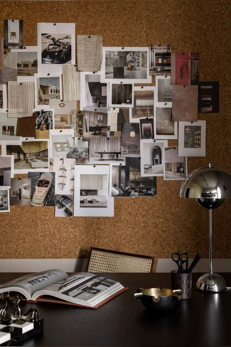 A visual moodboard on a cork wall above a creative studio desk